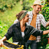 A young couple picking berries.